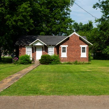 A small single-family, one-story home set back from the road
