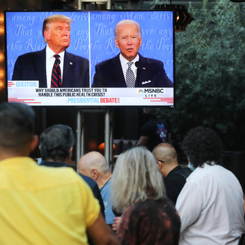 People sit and watch a broadcast of the first debate between President Donald Trump and Democratic presidential nominee Joe Biden.
