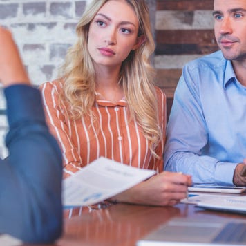 Young couple speaking to a banker