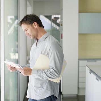 Man sorting mail at home