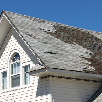 A close-up of a roof in desperate need of repair.