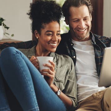 A couple explores their mortgage options online