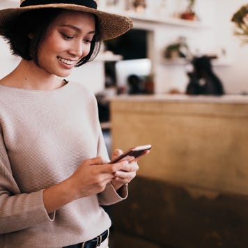 A woman looks at her phone.