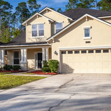 A two-story home with attached garage and columns