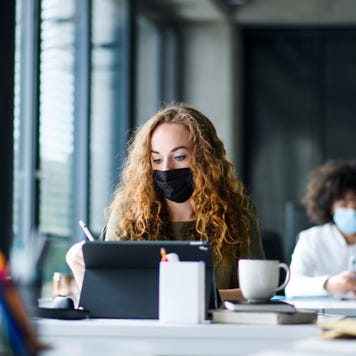 Woman studies while wearing mask