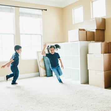 Children playing in an empty house on moving day