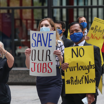 Airline industry workers hold signs during a protest in Chicago