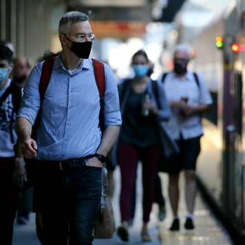 Commuters arrive at South Station in Boston wearing masks.