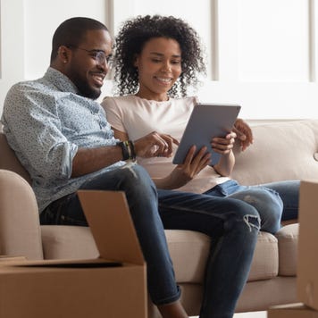 Couple sits on the couch in their new home