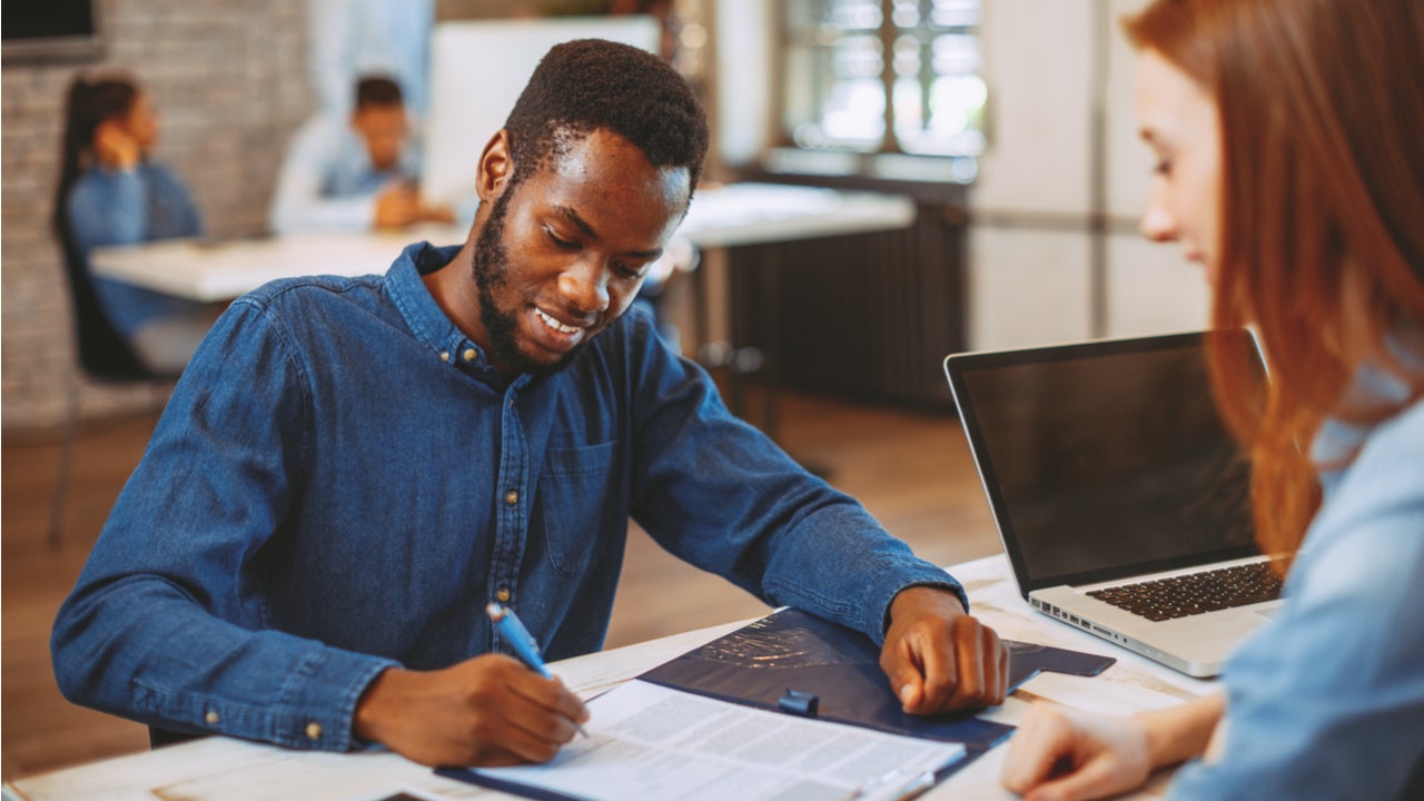 Man signs paperwork