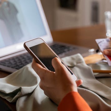 Person holding phone and credit card