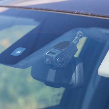 Shot of a dash cam seen through the front of a windshield.
