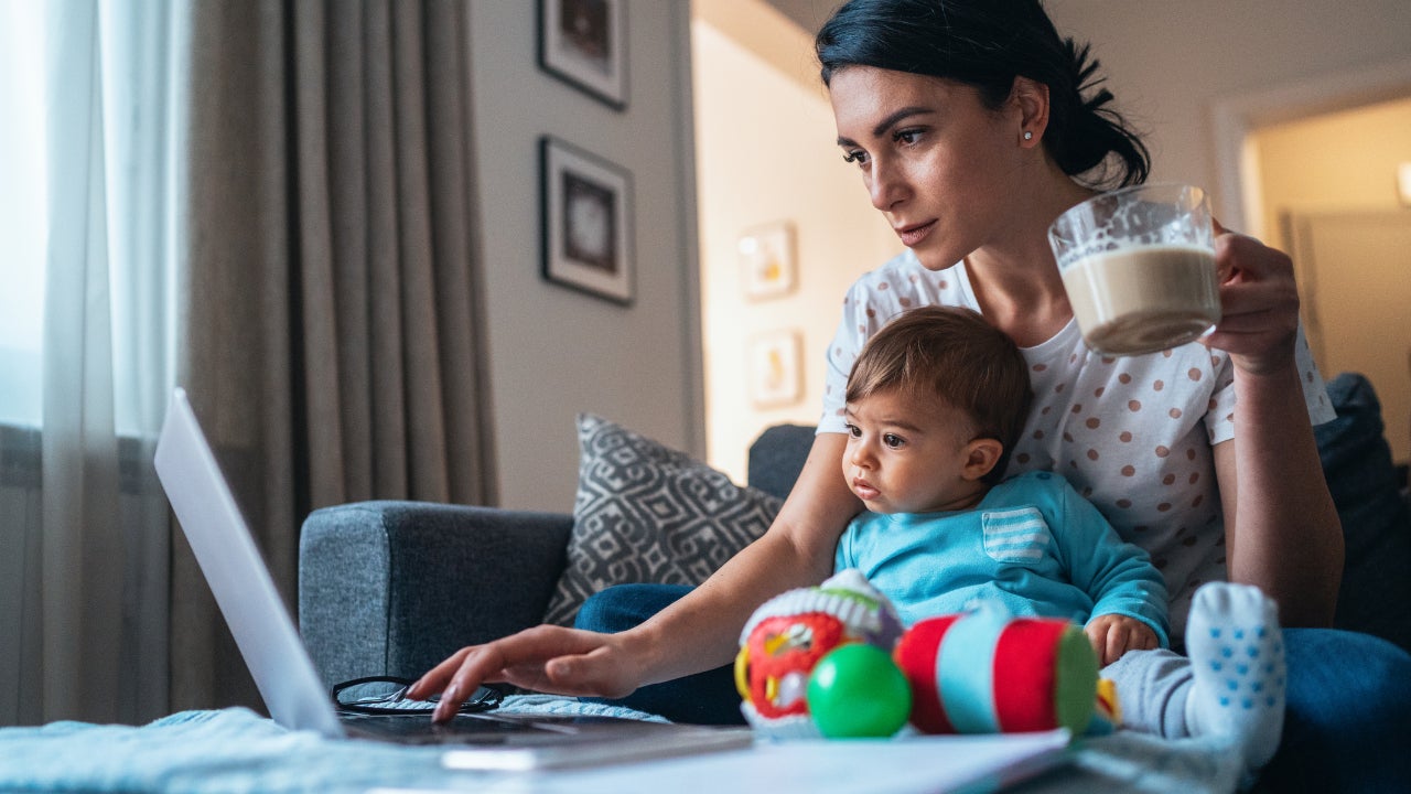 Mom at home on computer with her young son