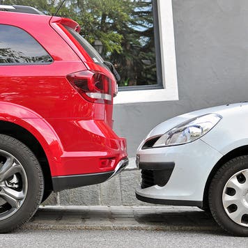 SAINT GERVAIS, FRANCE - AUGUST 13: Two cars parked in the street of Saint Gervais on August 13, 2015. Saint Gervais is a commune in the Haute-Savoie, France.