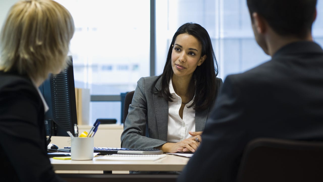 An insurance agent talking to clients