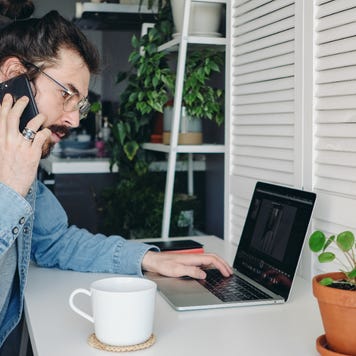 A man does research on his laptop.