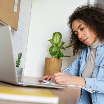 Woman works on laptop at a desk
