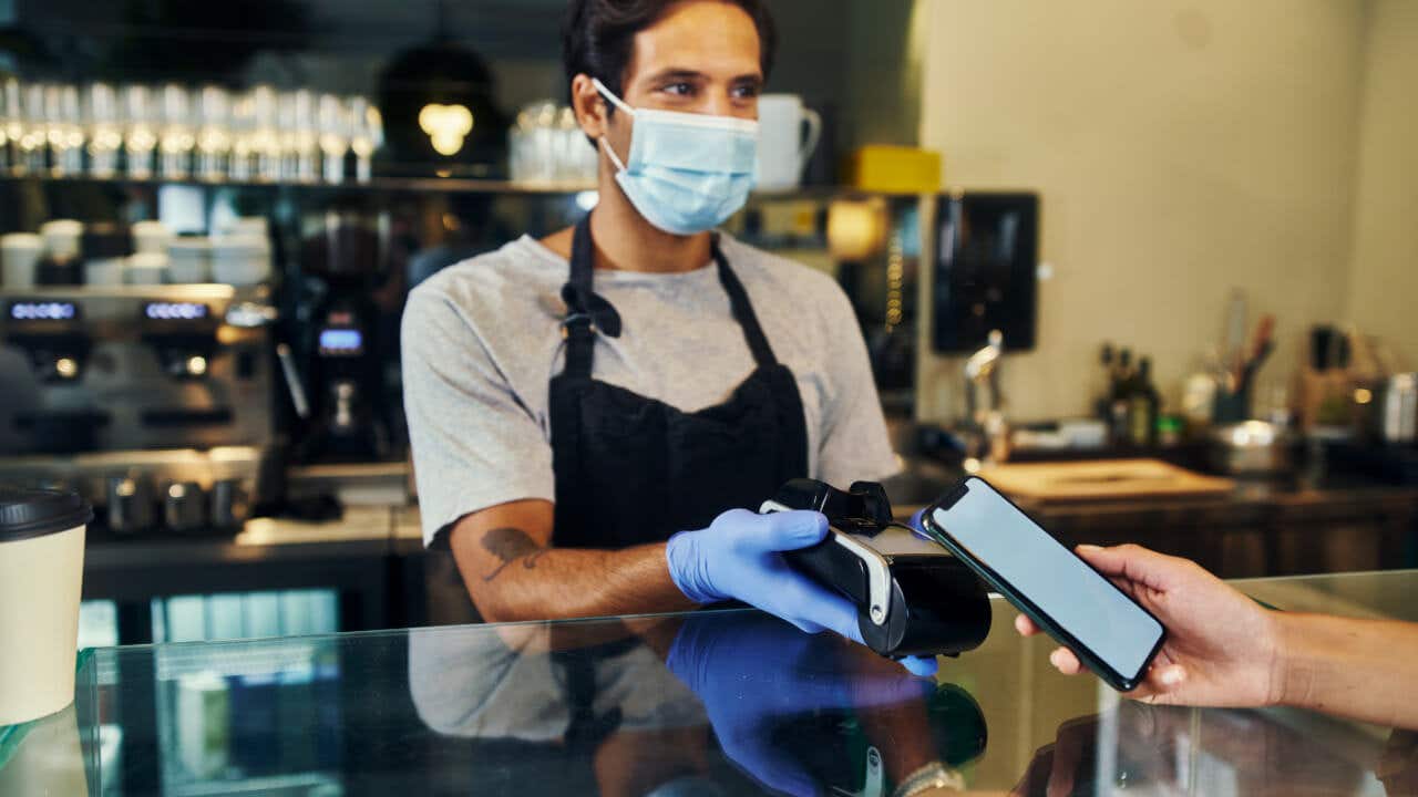 Cashier accepting contactless payment