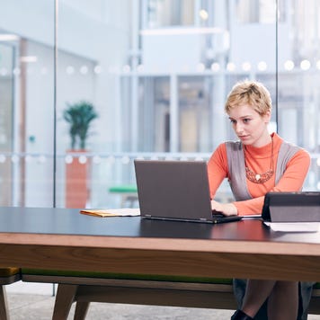 Woman in laptop in corporate building