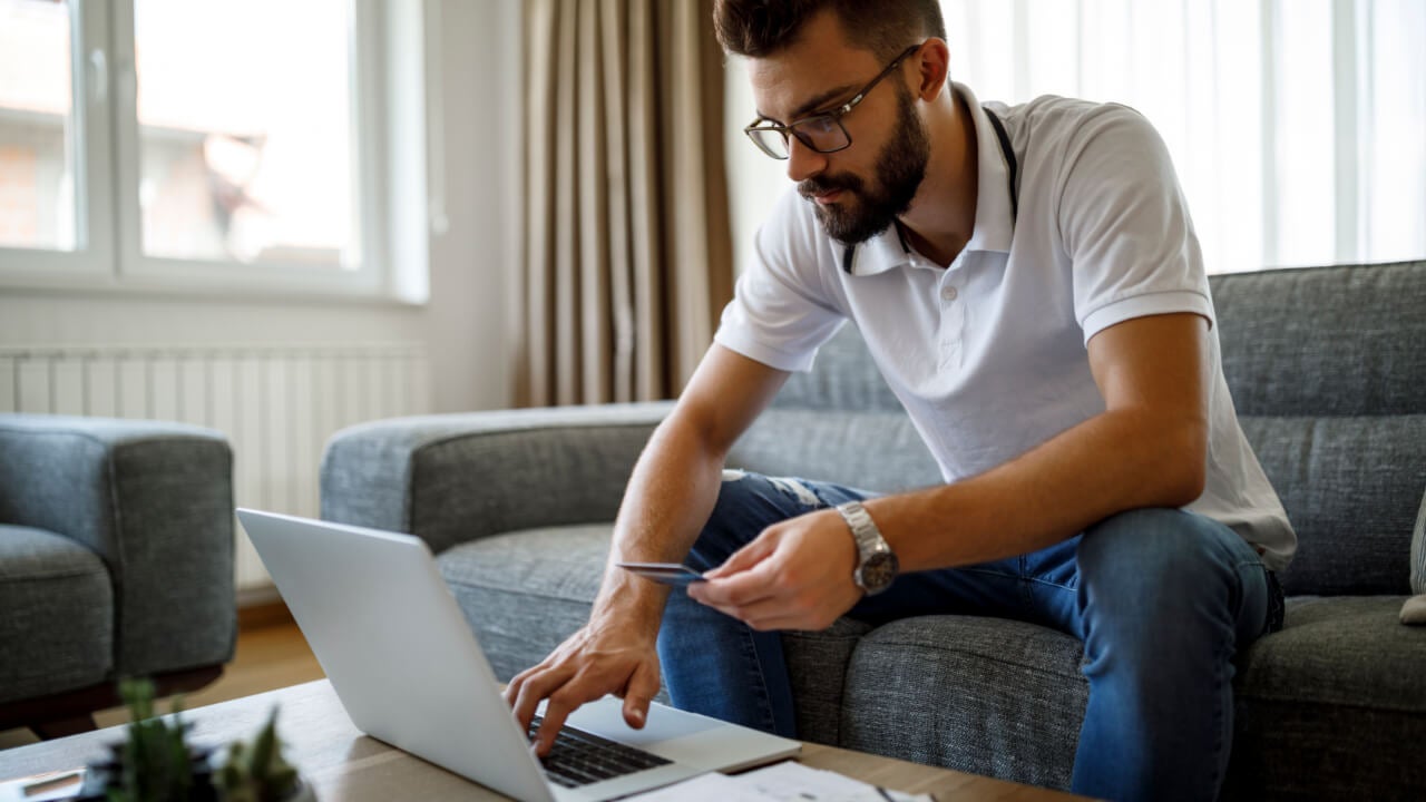 Man with credit card and laptop