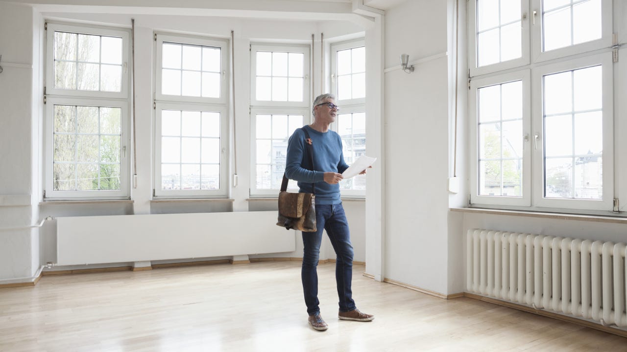 Man looking around in empty apartment