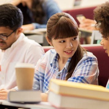 College students talk in a lecture hall