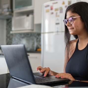Woman working on her laptop from home