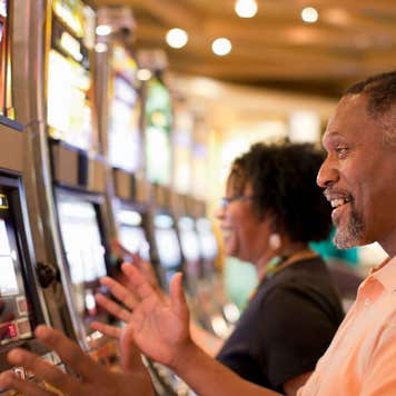 Couple playing slot machines at a casino