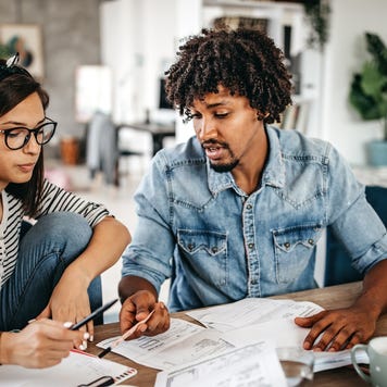Multi-ethnic couple planning their home budget