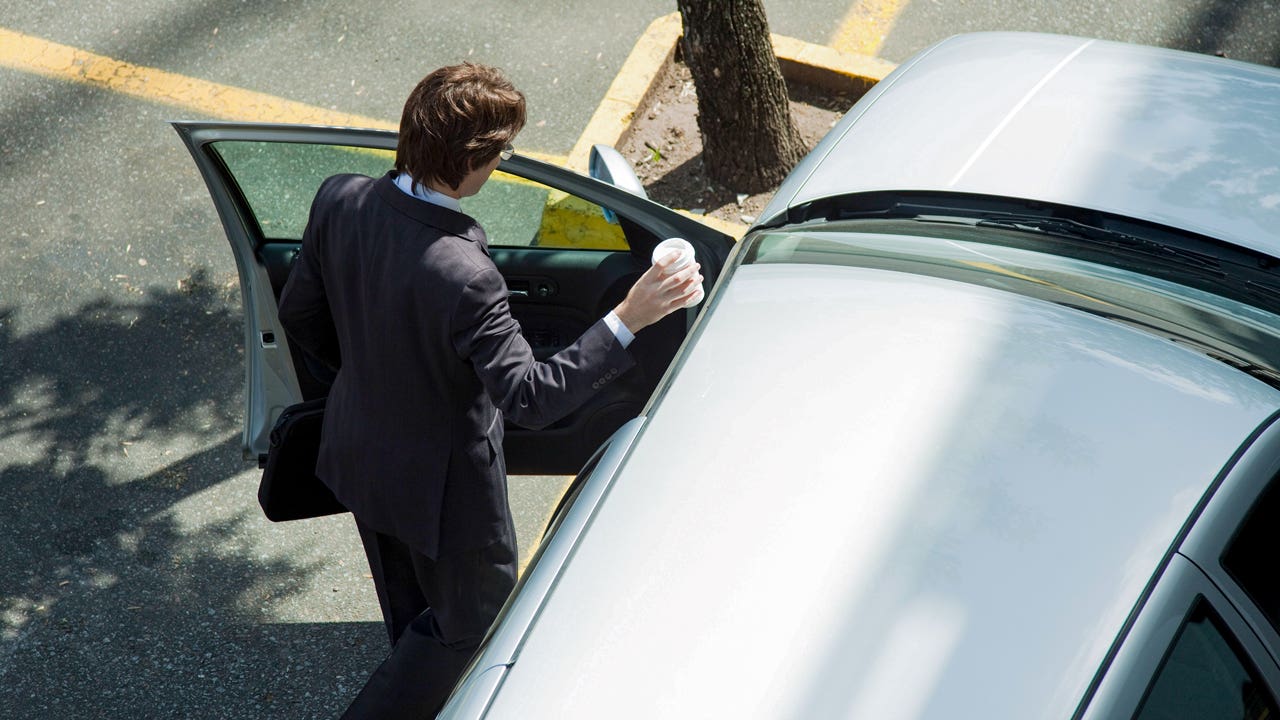 man getting into his car