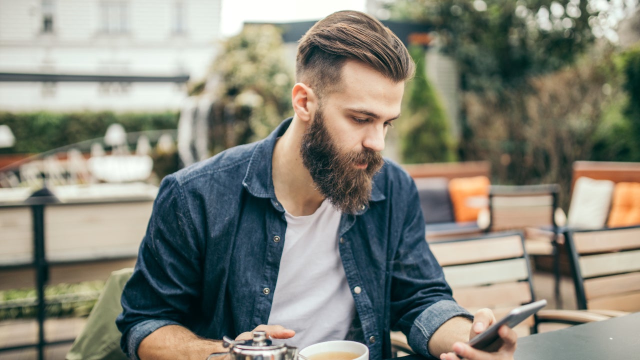 Millennial man looking at smartphone