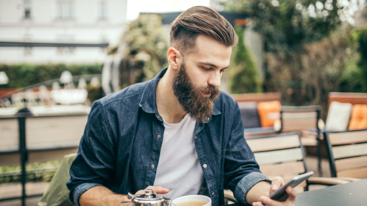 Millennial man looking at smartphone