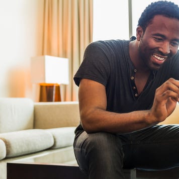Man using cell phone in living room