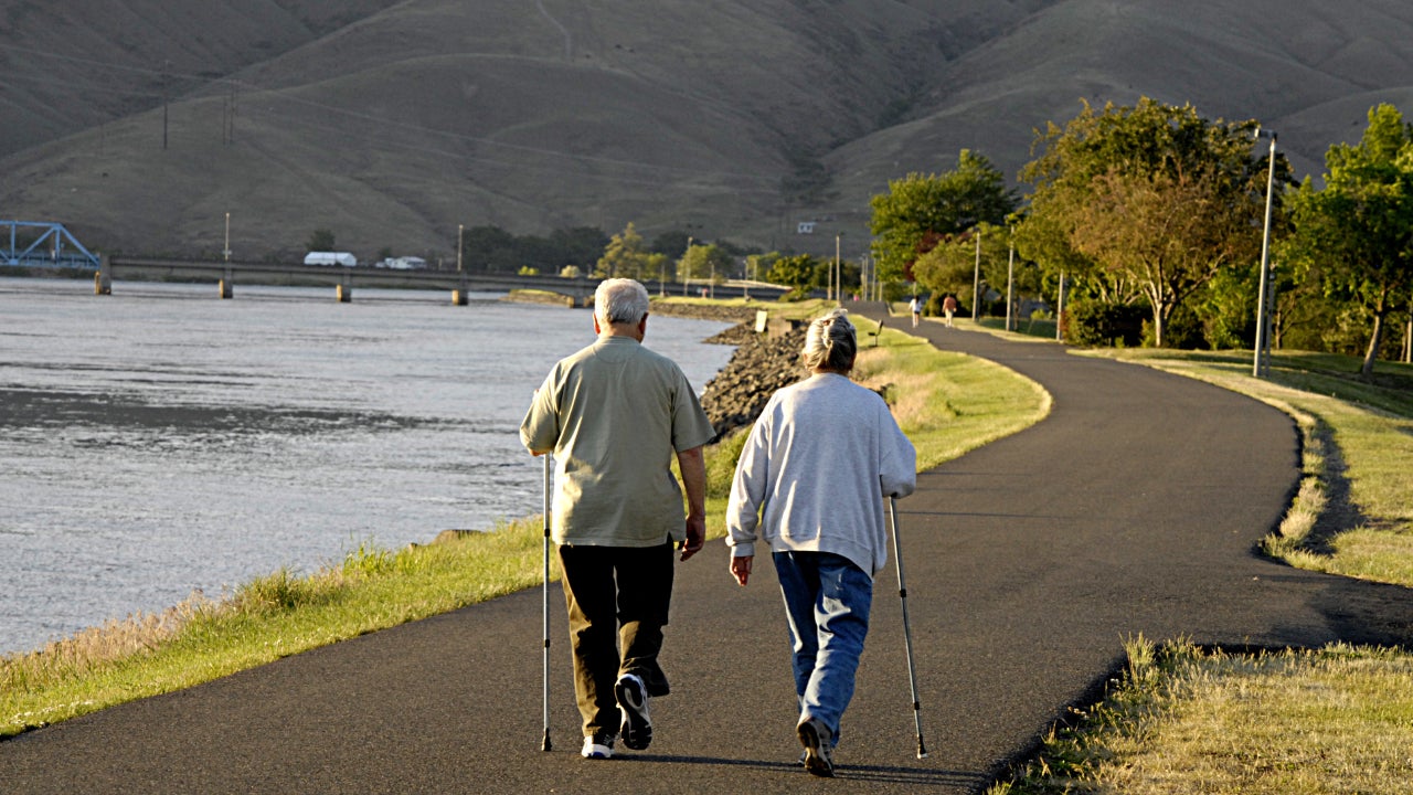 Couple walking along water.