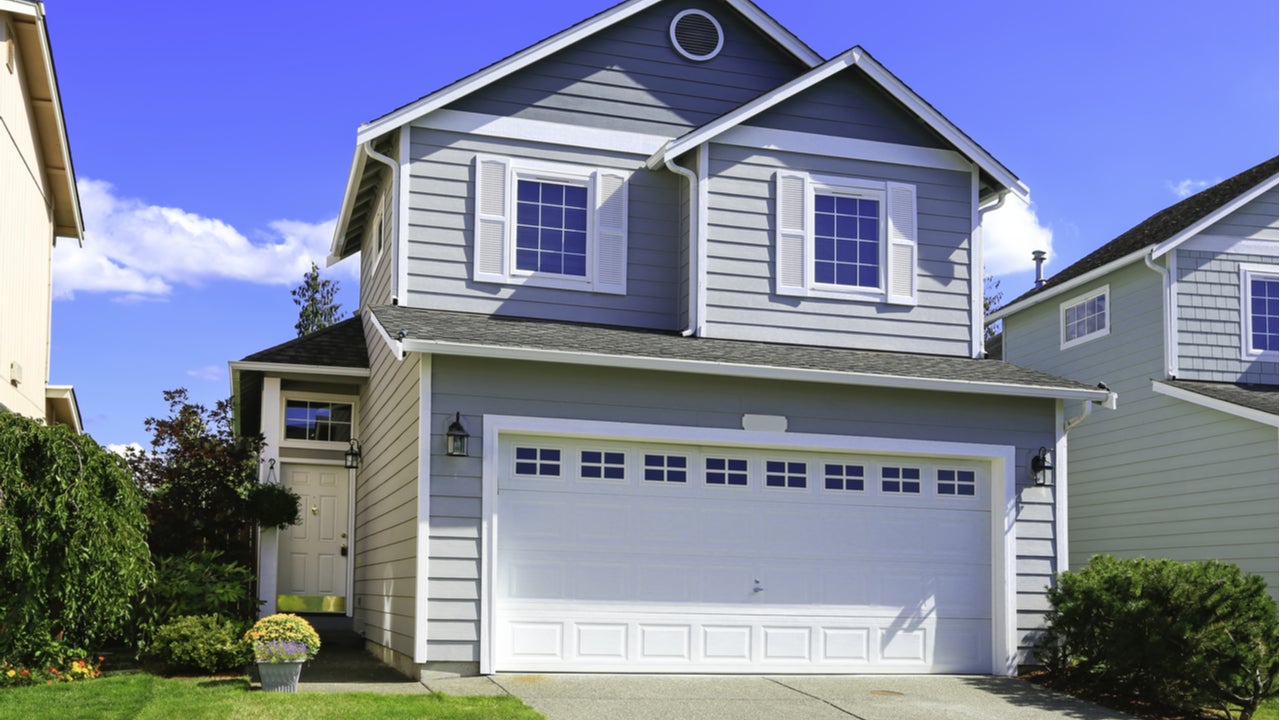 The exterior of a two-story single-family home with attached garage and driveway