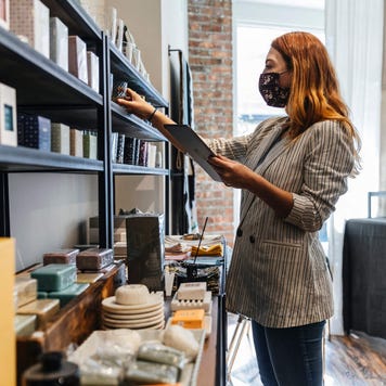 Small business owner takes inventory in her shop