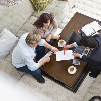 Businessman talking with couple