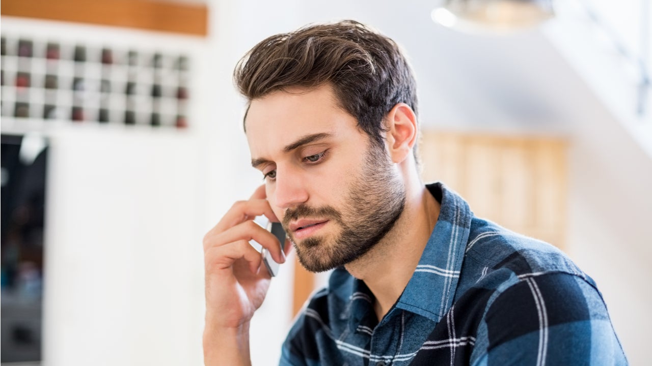 Concerned man talks on the phone