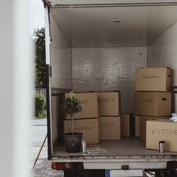 Cardboard boxes arranged in back of moving truck
