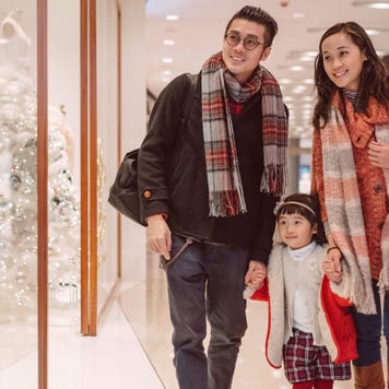 Happy family strolling in shopping mall