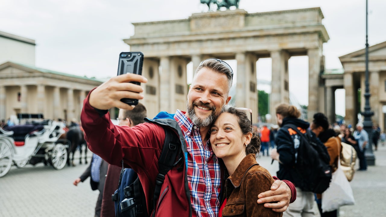 A Mature Couple Take A Selfie Together In Front Of Brandenburg Gate in Berlin