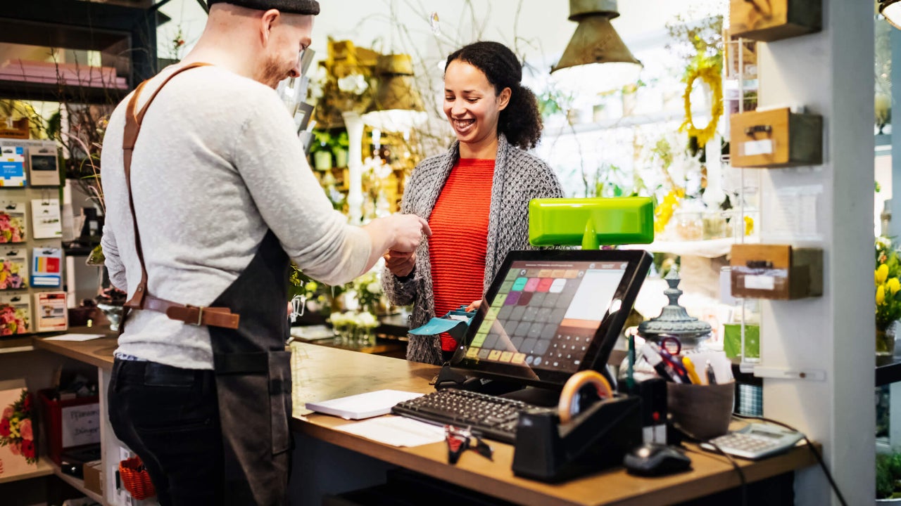 Smiling woman paying with her credit card in a store