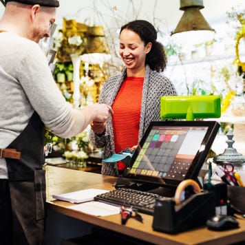 Smiling woman paying with her credit card in a store
