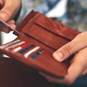 man pulling card out of wallet