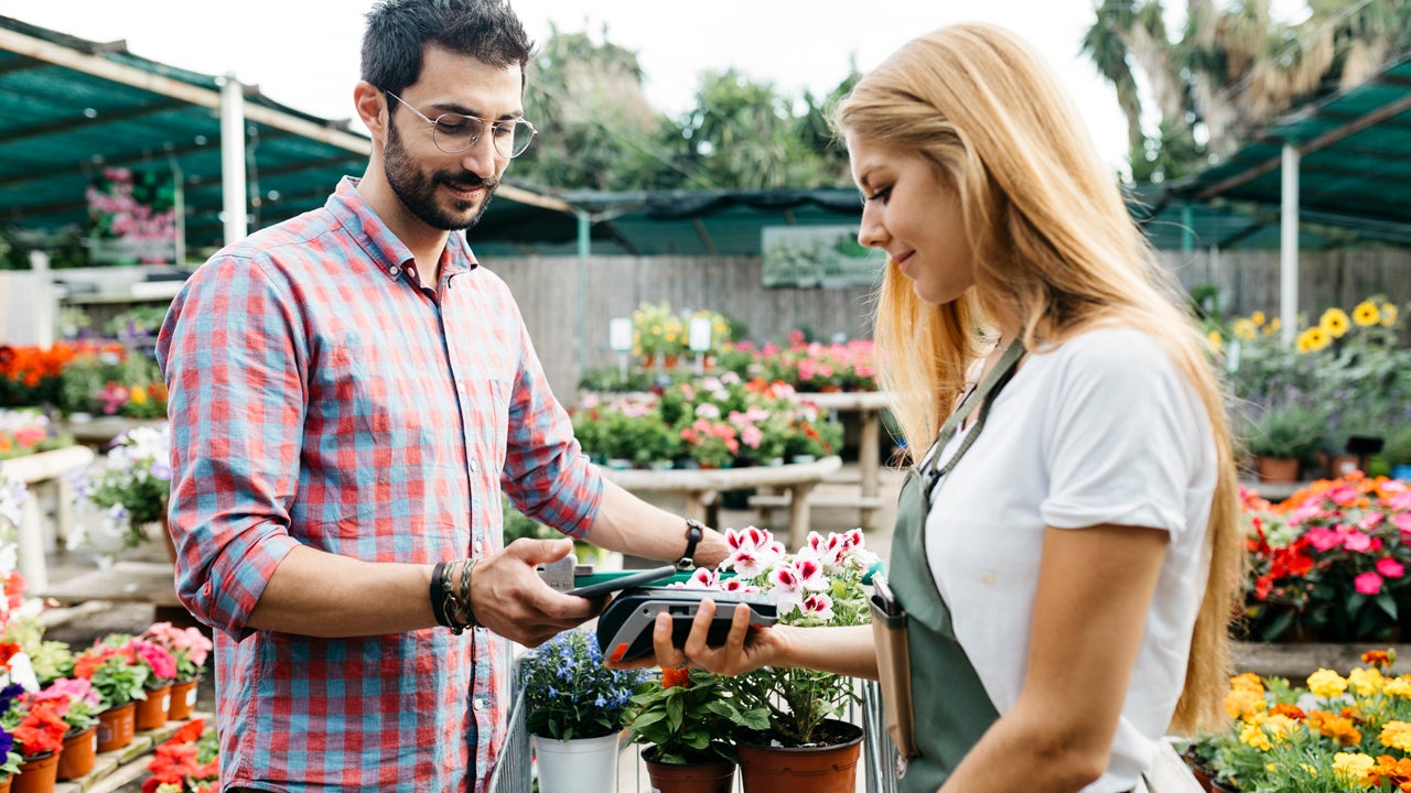 man buying flowers at garden center