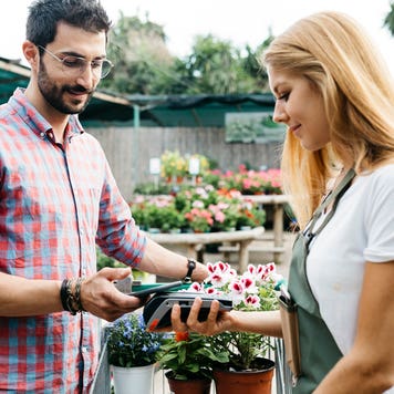 man buying flowers at garden center