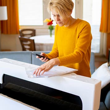 Young woman unboxing a television