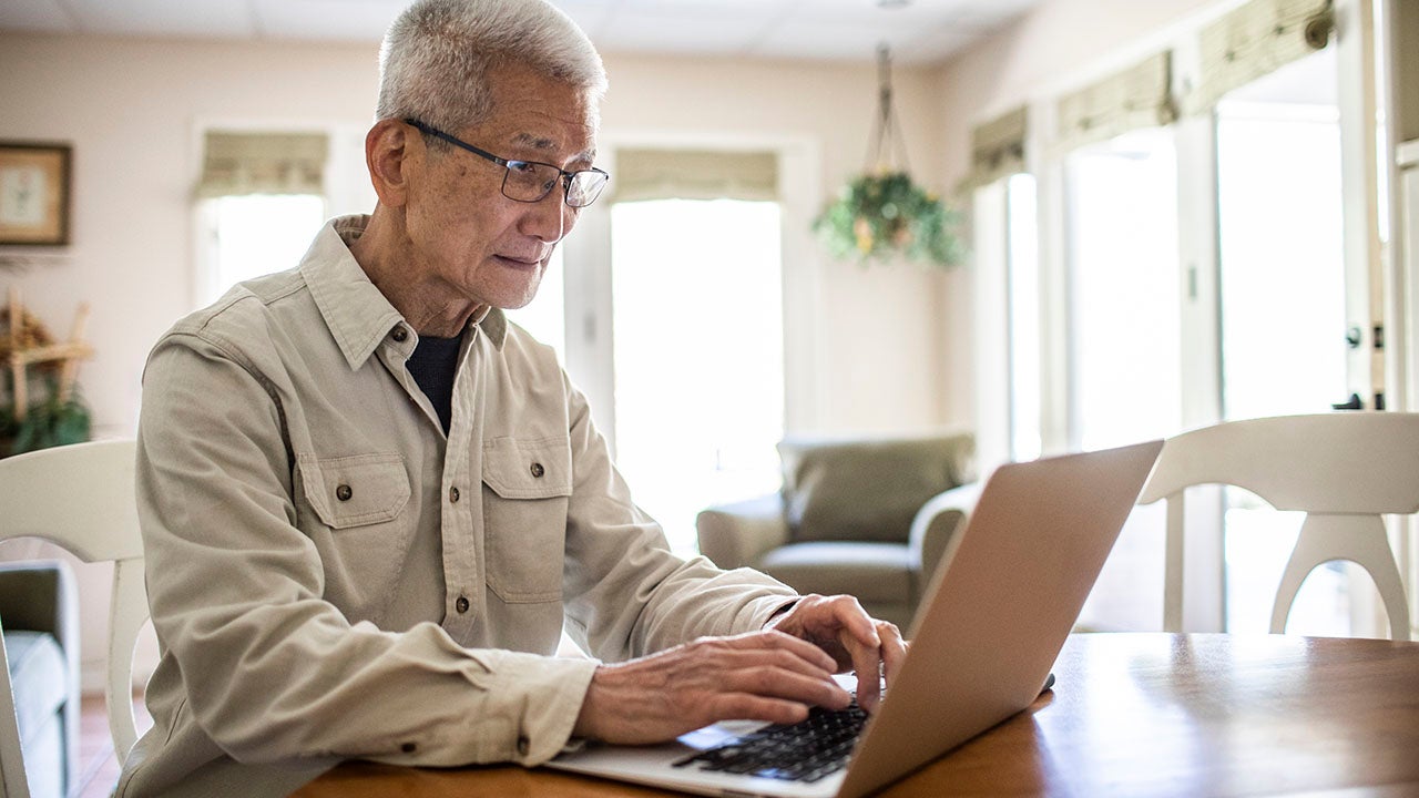 Person using laptop computer at home