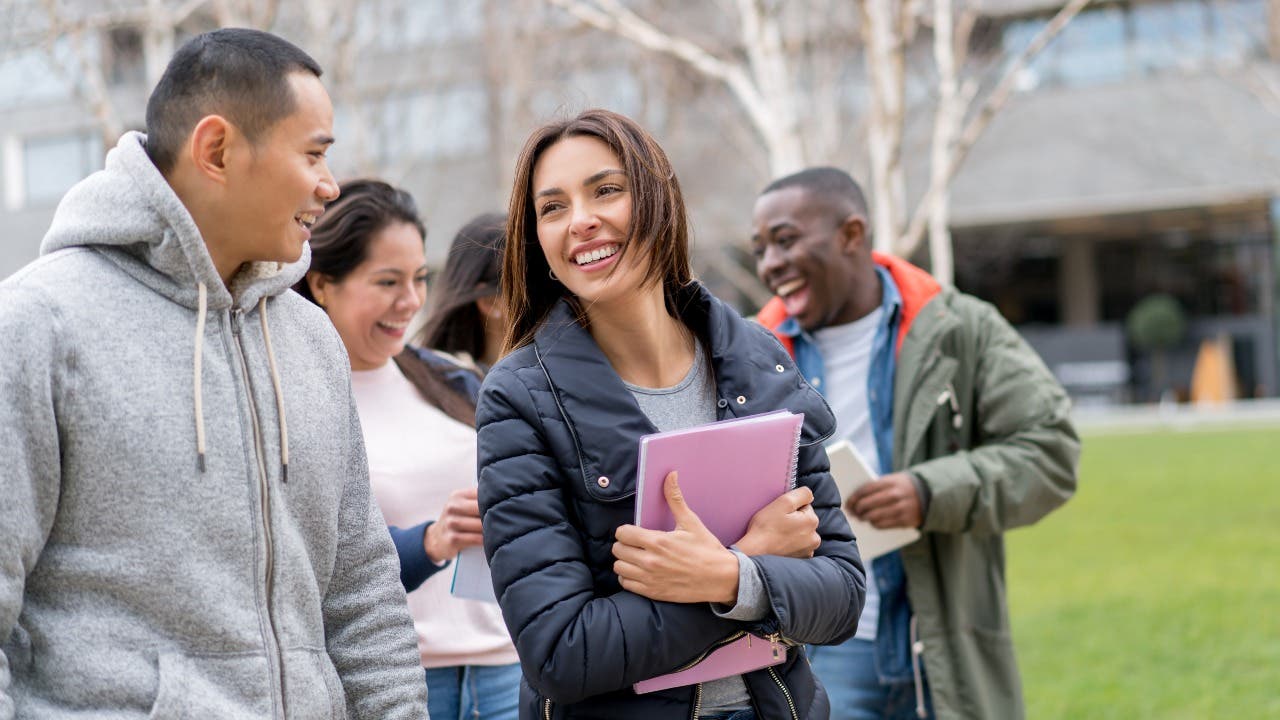 Group of college students walk on campus