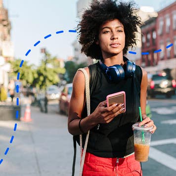 young person walking on an urban sidewalk